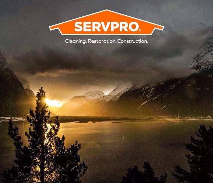 Mountains surrounded by clouds and rain with SERVPRO logo